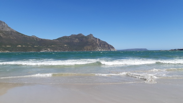 Waves lapping the beach in Hout Bay, looking towards Chapman's Peak